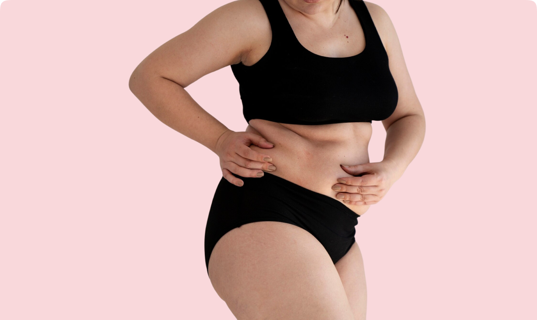 Frau greift sich an den Bauch – Symbolbild für Blähungen und Gewichtsprobleme
